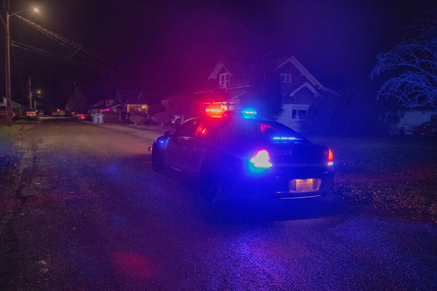 FILE PHOTO &mdash;&nbsp;A Centralia police car blocks off a road while shining a spotlight during a Centralia Police K9 unit search for a man wanted for a felony warrant in Centralia&rsquo;s Logan district on Jan. 11.