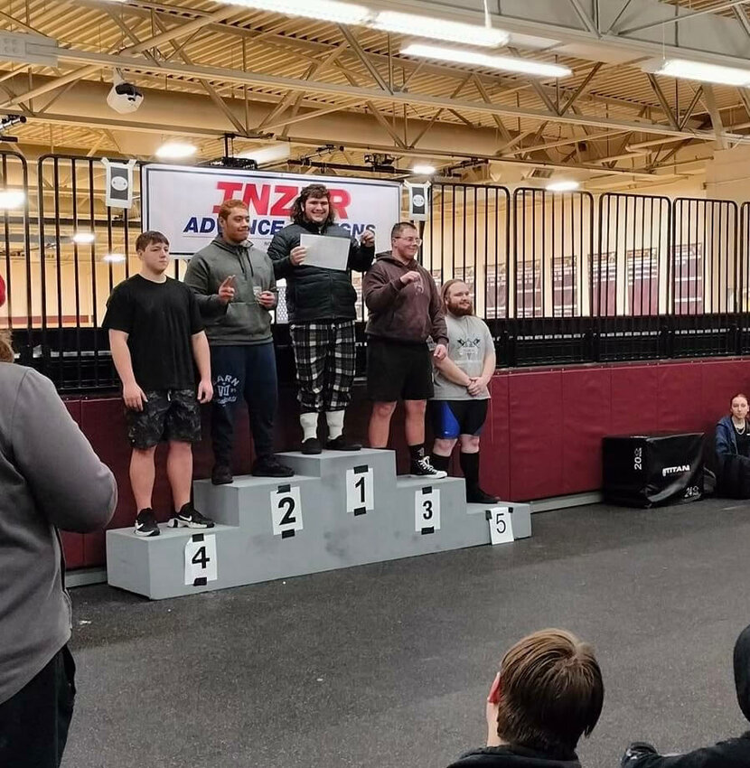 Yelm High School's Landen Barger, center, placed first in the unlimited weight class at a powerlifting competition, recently.