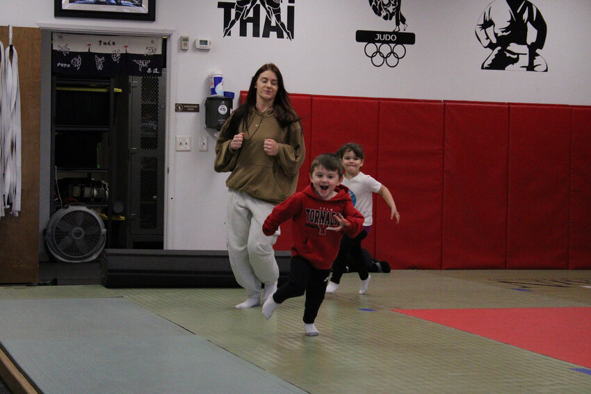Leah Simmons and her son go for a warm-up jog at a Crawl PNW parent and toddler judo class on Jan. 10.
