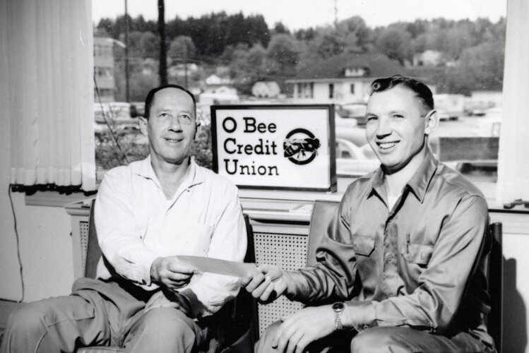 Founder Ted McGill, left, is pictured with an O Bee Credit Union member in this photo provided by the credit union.
