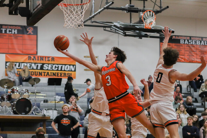 James Grose splits three defenders on the way to the basket during the second half of Napavine's 89-45 win at Rainier on Jan. 17.