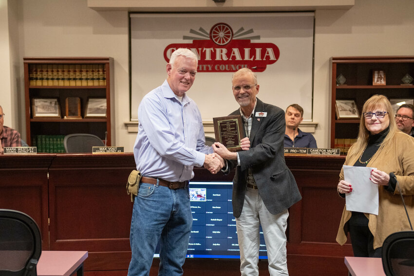Peter Lahmann accepts a plaque presented by City Council member Max Vogt for being named 2023 Volunteer of the year in Centralia during a Jan. 23. Centralia City Council Meeting.
