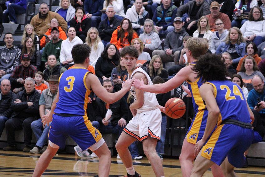 Josh Meldrum flips a pass behind his back while surrounded by three Adna defenders on Jan. 26.