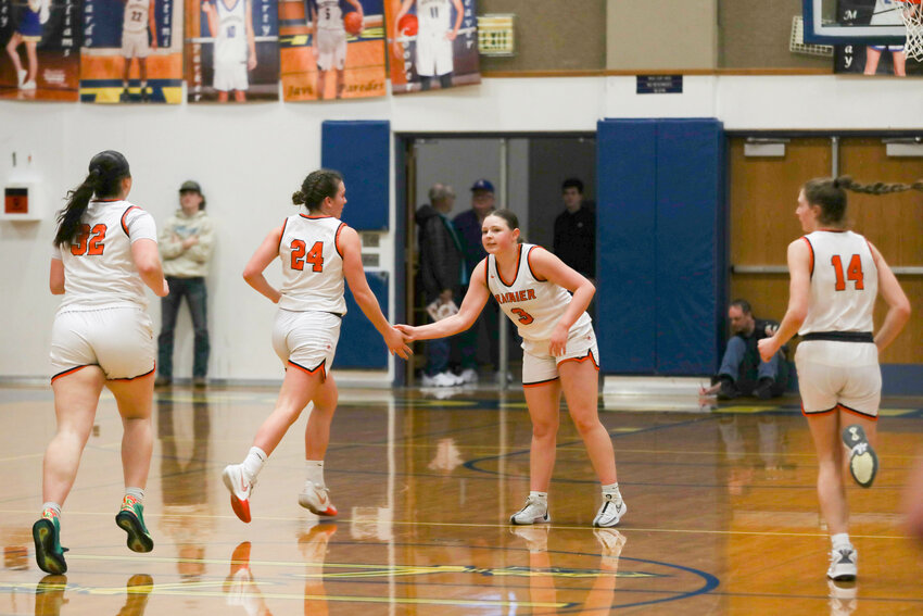 Brooklynn Swenson high-fives Bryn Beckman during Rainier's 66-43 win over Morton-White Pass in the first round of the 2B District 4 Tournament on Feb. 3 in Rochester.