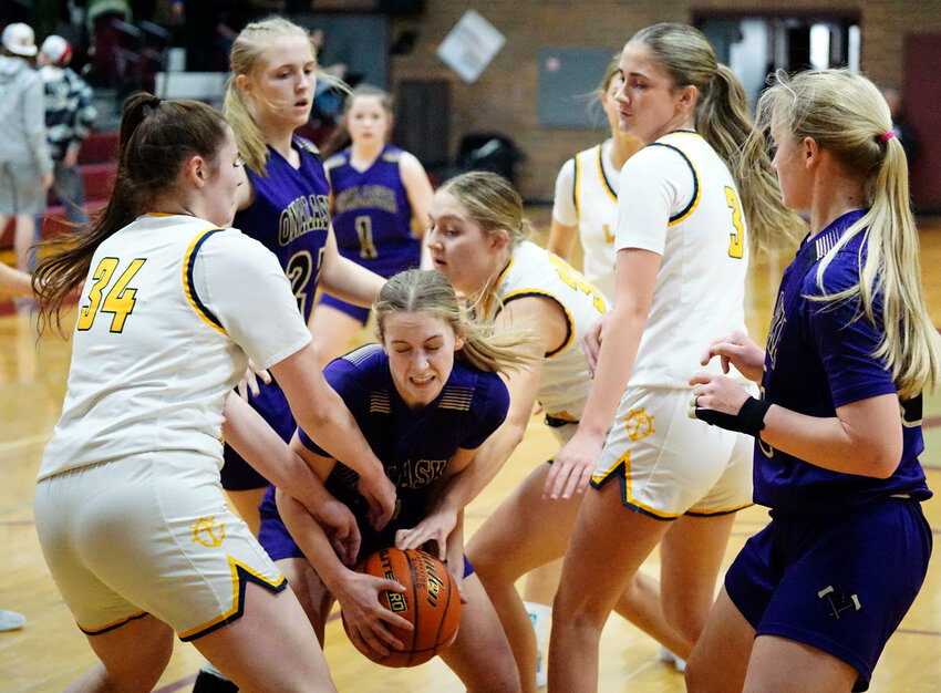 Onalaska guard Jaycee Kinsman grabs an offensive rebound against the Ilwaco defense at the opening round of the District 4 2B playoffs in Montesano on Feb. 3.