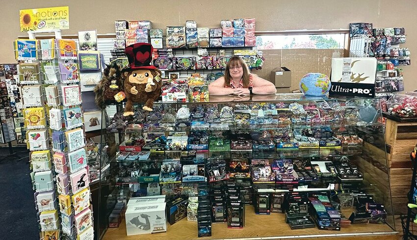 Funtime Toys owner Heather Ekland poses behind the counter at the store’s new location.