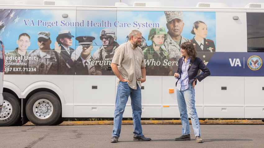 Veterans Memorial Museum Executive Director Chip Duncan talks with Congresswoman Marie Gluesenkamp Perez outside of the Veterans Affairs Puget Sound Health Care System American Lake Mobile Medical Unit in Chehalis on Aug. 23, 2023.
