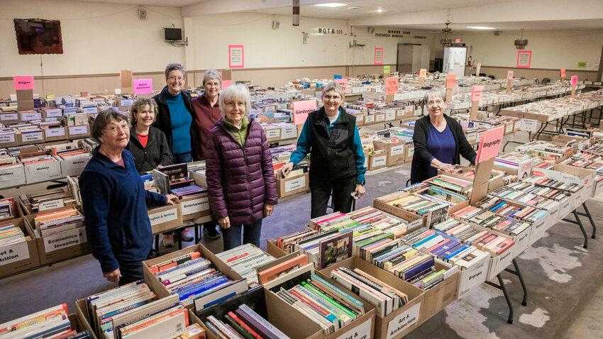 From left, Jo Martinez, Cathy Cavness, Laura Hewett, Betty Garrett, Kristi Nelson, Donna Loucks and Renae Seegmiller pose for a photo while setting up the AAUW Used Book Sale at the Moose Lodge in Centralia in 2023.