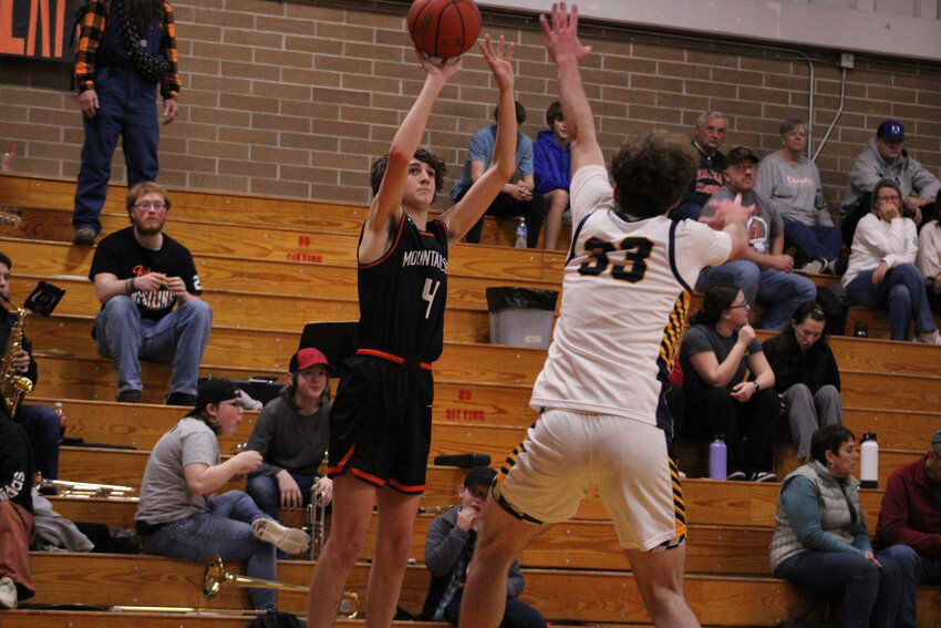 Johnny Boesch shoots a 3-pointer over the outstretched arm of an Ilwaco defender on Feb. 9. Boesch finished with a team-high 22 points in the loss.