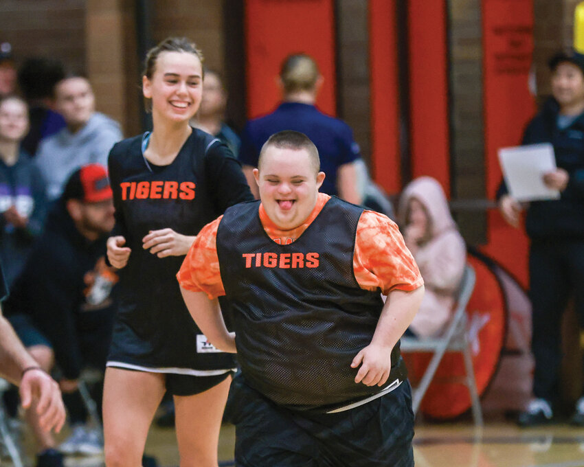 An athlete with Battle Ground&rsquo;s unified basketball program celebrates after making a basket in a game against Evergreen High School on Saturday, Feb. 10, during the district tournament.