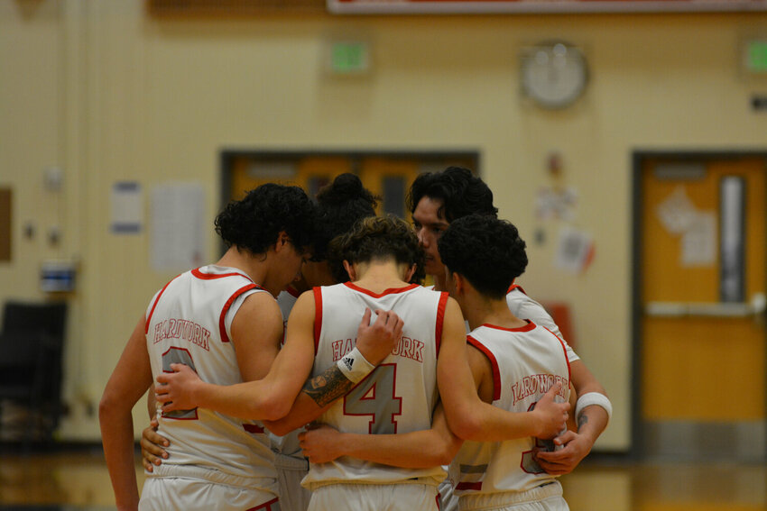 Yelm's starting varsity basketball lineup huddles for a pre-game speech on Dec. 22, prior to the contest against Timberline.