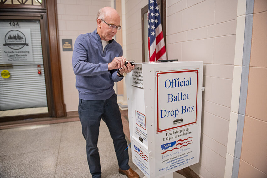 Lewis County Auditor Larry Grove locks a ballot box inside the Lewis County Courthouse at exactly 8 p.m. on Feb. 13 in Chehalis.