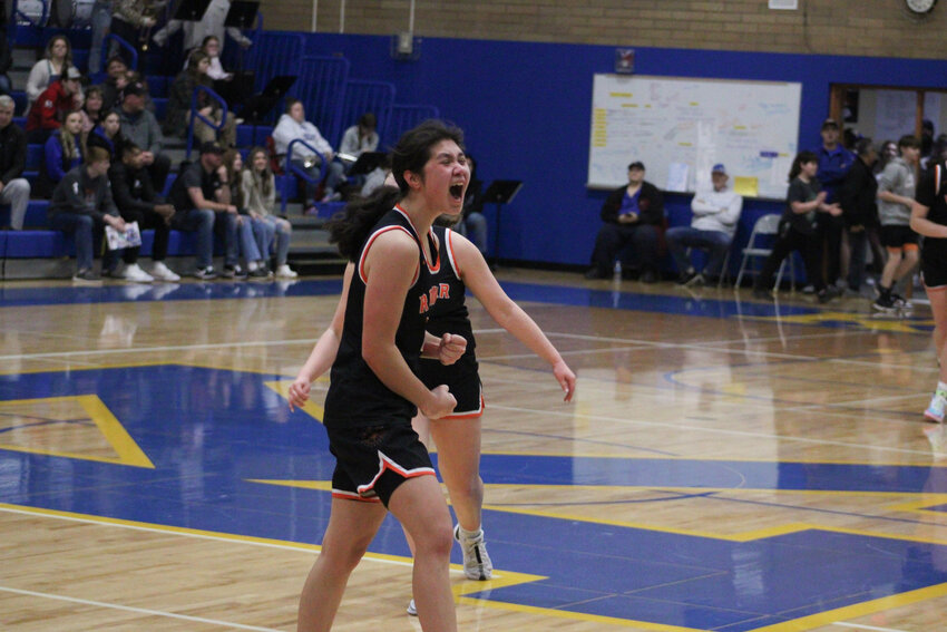Angelica Askey lets out a yell after the final buzzer sounds. Rainier defeated Adna, 49-44, on Feb. 13 to clinch a trip to state.