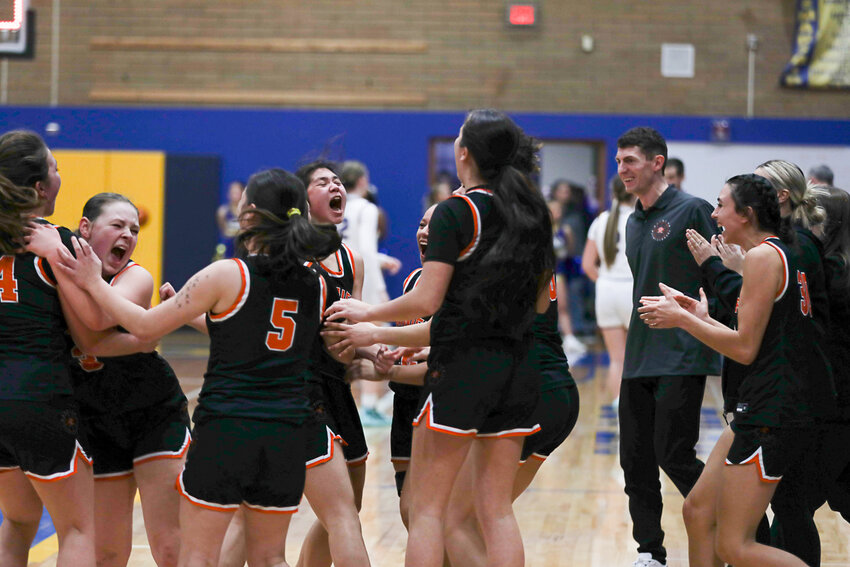 The Rainier Mountaineers celebrate after their 49-44 win over Adna in the 2B District 4 semifinals at Kelso on Feb. 13.
