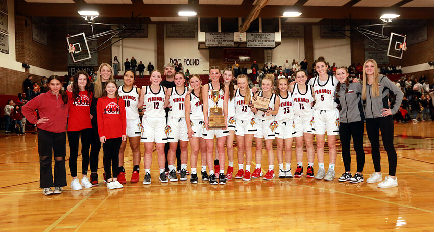 The Mossyrock girls basketball team poses with the District Championship trophy after its 46-30 win over Taholah at Montesano on Feb. 17.