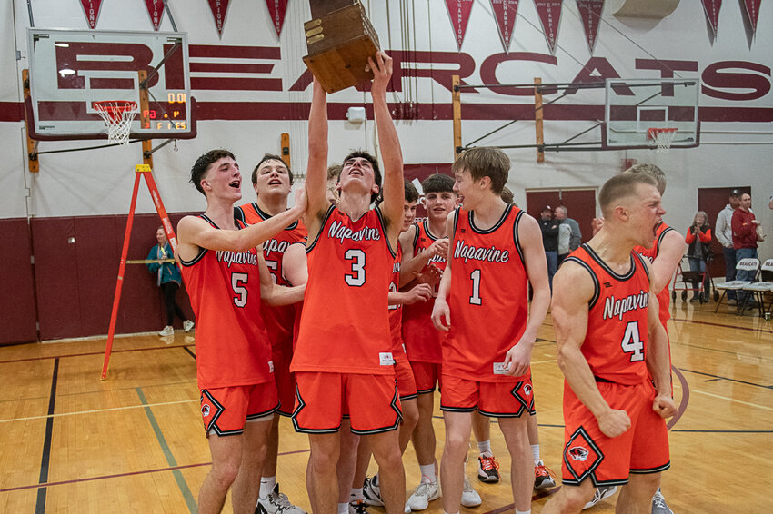 James Grose holds up the District 4 trophy after Napavine's District Championship win over Adna on Feb. 18. in Chehalis.