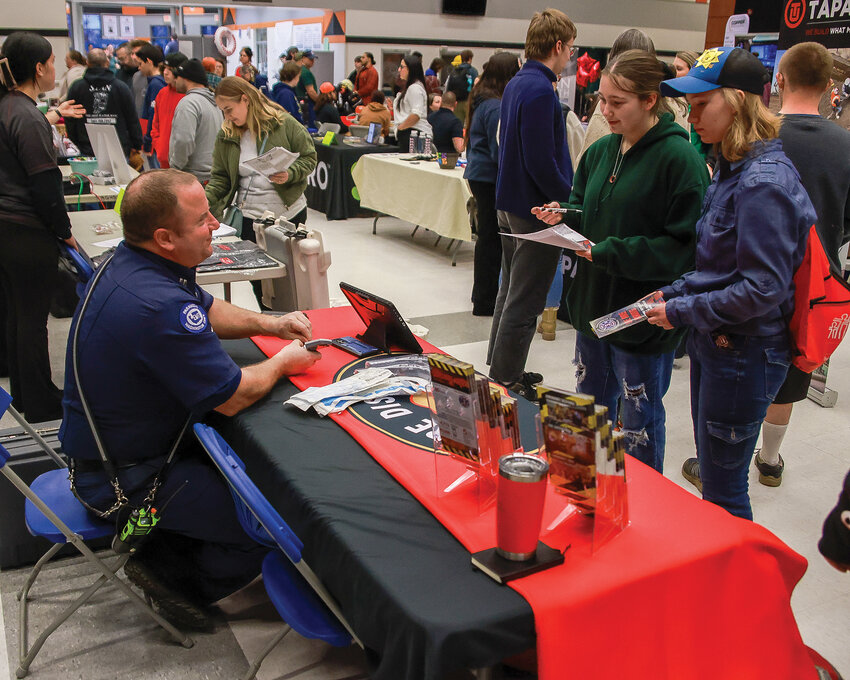 Students visit Clark County Fire District 3&rsquo;s booth during the Battle Ground Public Schools industry fair at Battle Ground High School on Thursday, Feb. 15.