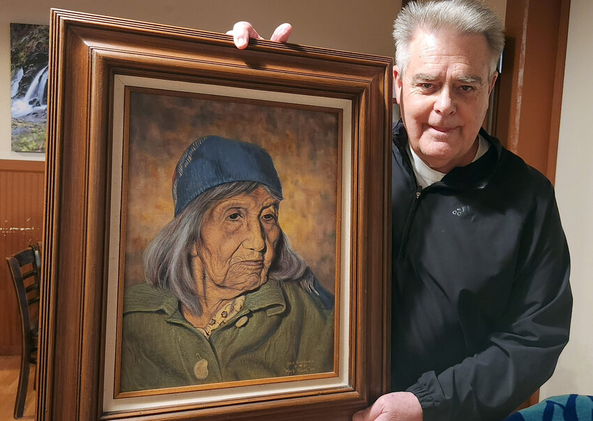 Jim Chromey poses with a commissioned portrait of Mary Kiona in this photo by Chronicle columnist Julie McDonald.
