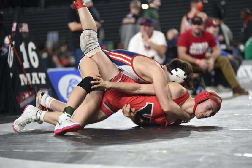 Yelm's Kaleb Holman, 165, wrestles Ferris's Jack Neale on Friday, Feb. 16 in the opening round of Mat Classic XXXV.
