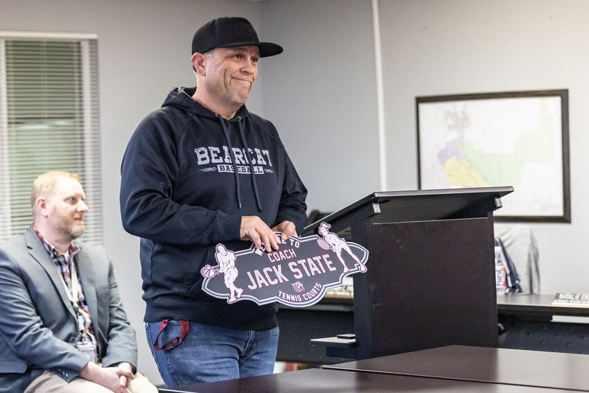 Don Bunker holds up a mock-up of the new tennis courts sign honoring Jack State during the Chehalis School Board meeting on Tuesday, Feb. 20, 2024.
