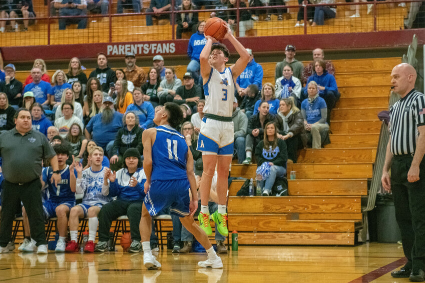 Braeden Salme shoots a three during Adna's overtime win over La Conner on Feb. 24.