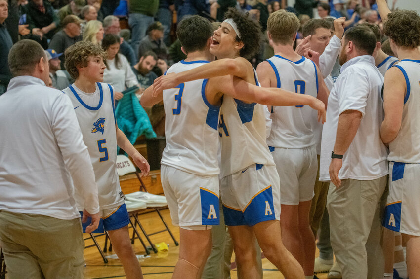 Adna teammates Jens Neilson (smiling) and Braeden Salme embrace after its Class 2B elimination game victory over La Conner in overtime on Saturday night at W.F. West High School. The two seniors combined for 46 points in the Pirates' 66-62 win.