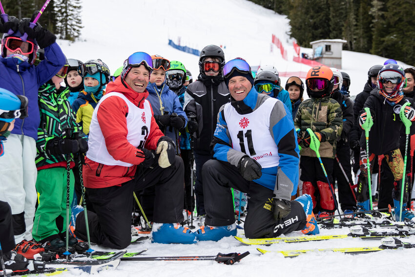 Steve Mahre, left, and Phil Mahre, right, pose for a picture with kids before racing at White Pass Ski Area on Saturday, Feb. 24, 2024.