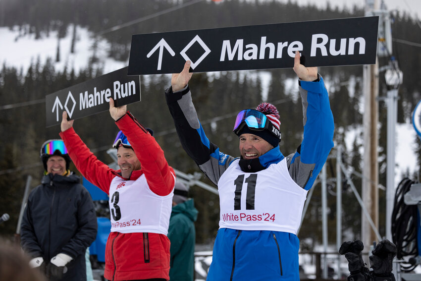 Steve Mahre, left and Phil Mahre hold up the new signs for a run named after them at White Pass Ski Area on Saturday, Feb. 24, 2024.