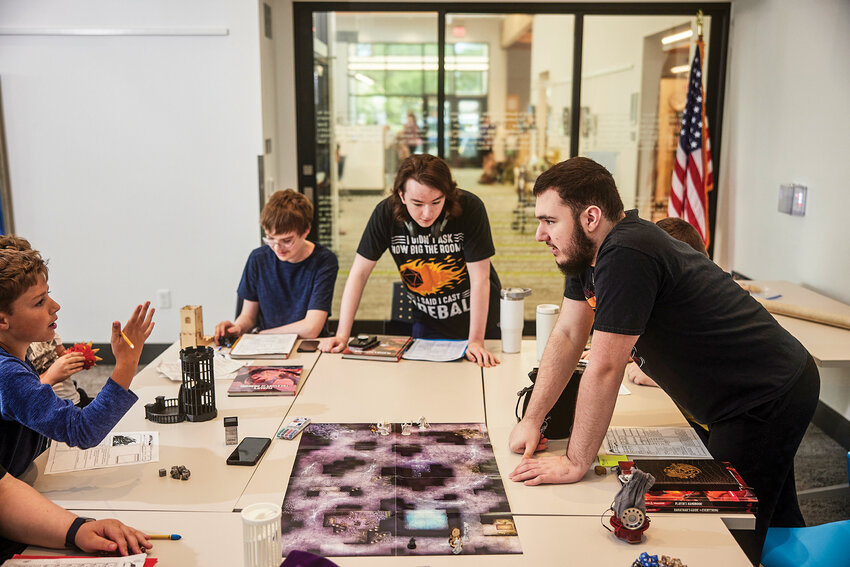 A pair of tweens giggle while playing Dungeons and Dragons at Ridgefield Community Library.