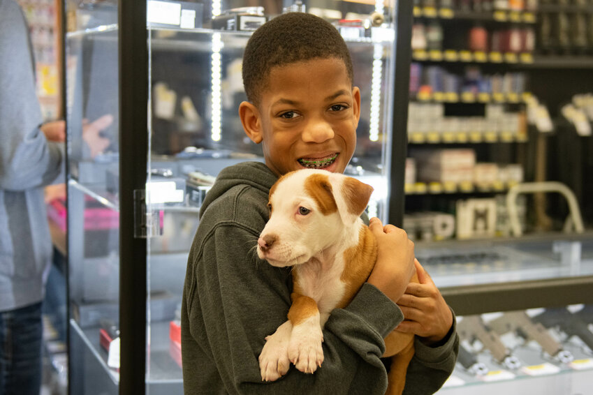 Zelein Euelm smiles with his new puppy Trapper at a pet adoption event hosted by Red Rose Animal Rescue at Chehalis Outfitters on Feb. 24. According to Red Rose Animal Rescue, which is based in Rochester, seven dogs and four cats were adopted through the event. To learn more about Red Rose Animal Rescue, follow them on Facebook at https://www.facebook.com/RedRoseAnimalRescue.