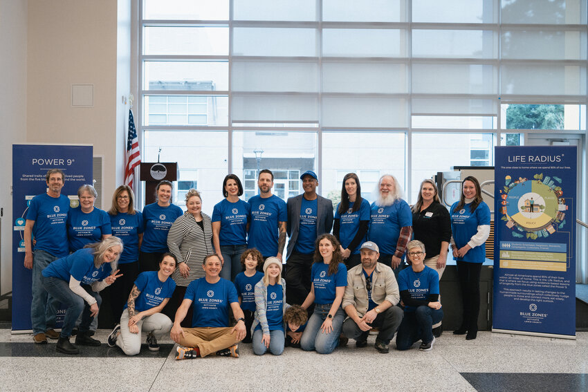 Lewis County volunteers are joined by a handful of staff members from Minnesota-based Blue Zones for a group photo at the Blue Zones Activate Lewis County kickoff event at Centralia College on Saturday, Feb. 24.