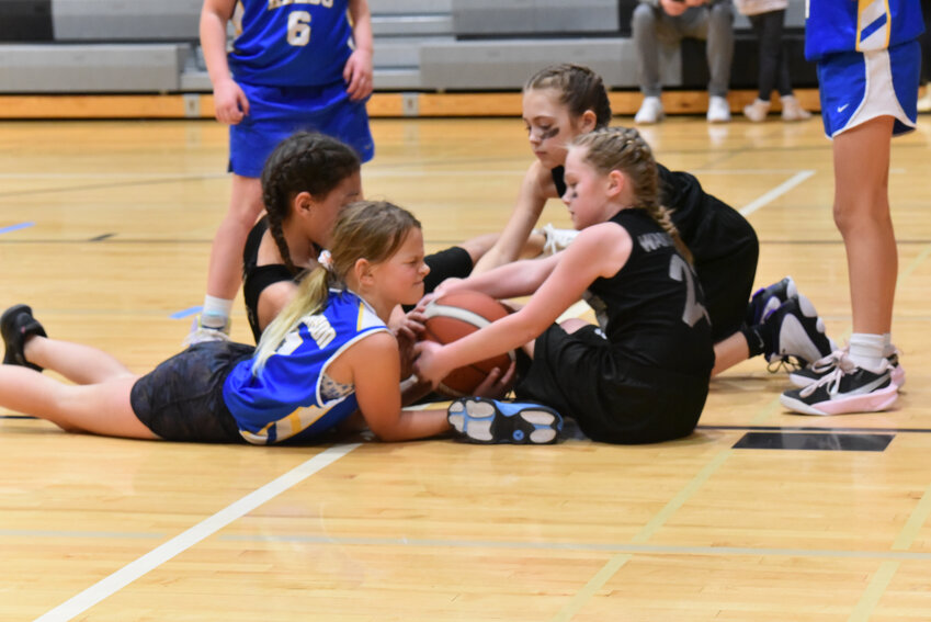 All three on-court participants in the Nyastrong Warriors Academy play aggressive defense and attempt to steal the ball from a Kelso athlete on Sunday, Feb. 25, at Tenino Middle School's second annual 3-on-3 tournament.