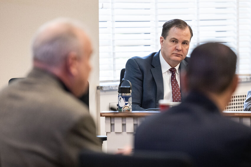 Sen. John Braun listens to Rep. Jim Walsh during a public hearing on income tax at the state Capitol on Tuesday, Feb. 27, 2024.
