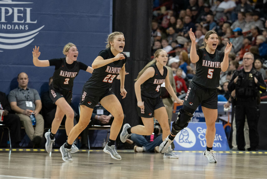 From the left, Hayden Kaut, Keira O'Neill, Grace Gall, and Dakota Hamilton celebrate after Napavine&rsquo;s 2B quarterfinal win over Brewster on Feb. 29. At the Spokane Arena.