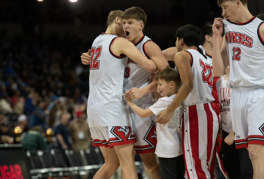 Easton Kolb hugs Hunter Isom after Mossyrock&rsquo;s 1B State semifinal win over DeSales on March 1 at the Spokane Arena.