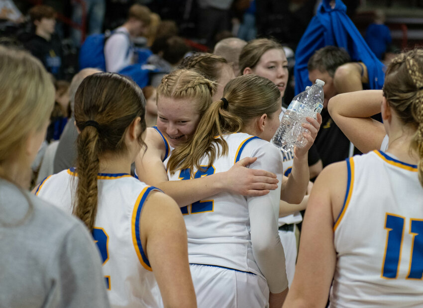 Sisters Ava and Margarite Humphrey hug after Adna's state third-place game versus Warden on March 2 at the Spokane Arena.