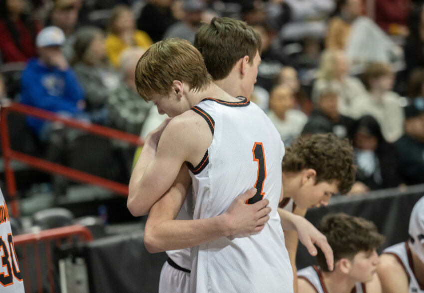 Jarin Prather and James Grose hug during Napavine's loss to Lake Roosevelt in the 2B 3rd/5th game on Mar. 2 in Spokane Arena.
