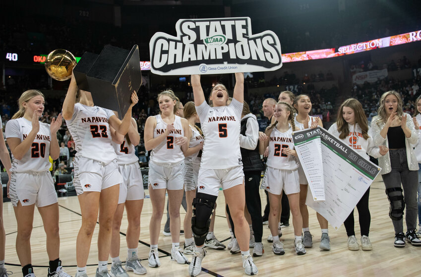 Dakota Hamilton holds up the state champions sign after Napavine's 2B state championship win over Okanogan on March 2 at the Spokane Arena.