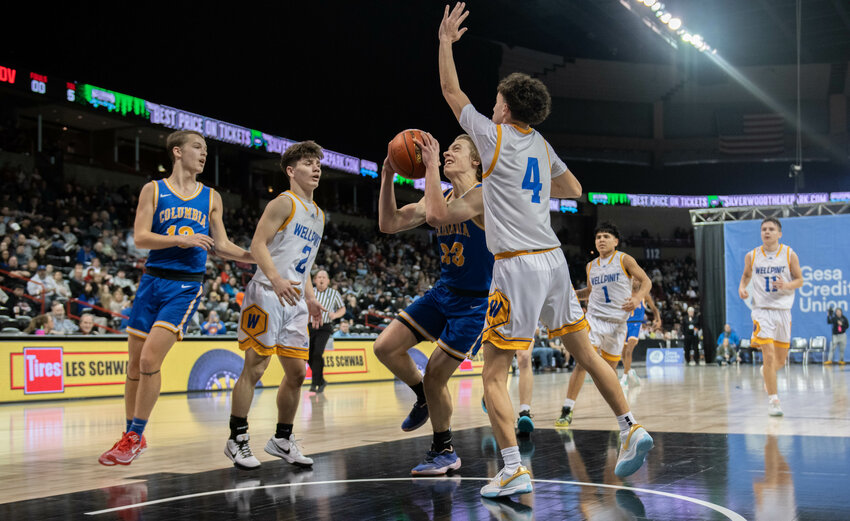 Tristan White drives to the hoop during Columbia Adventist&rsquo;s 1B quarterfinal matchup versus Wellpint on Feb. 29. At the Spokane Arena.