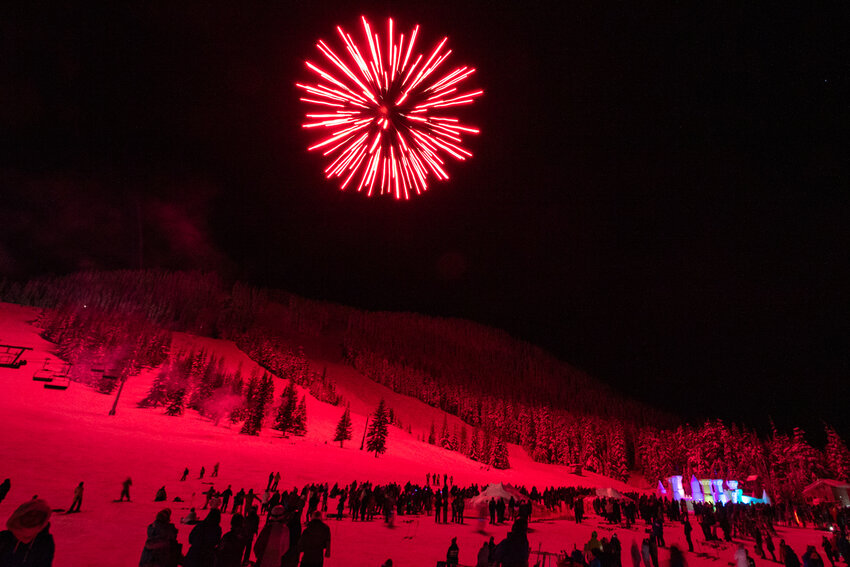 A red firework bursts as hundreds of &quot;Dragons vs. Dinosaurs&quot; Winter Carnival attendees enjoy a fireworks show on Saturday, March 2, at White Pass Ski Area.