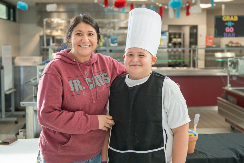 Contest winner Kason Talanoa smiles with his mother after the Future Chefs National Challenge at Orin Smith Elementary in Chehalis on March 7.
