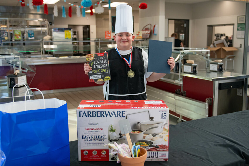 Contest winner Kason Talanoa smiles with his winnings while wearing his first place medal after the Future Chefs National Challenge at Orin Smith Elementary in Chehalis on March 7.