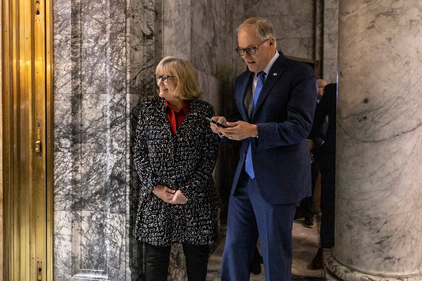 Gov. Jay Inslee and Trudi Inslee wait outside the House on the last day of the 2024 Legislature at the state Capitol on Thursday, March 7.
