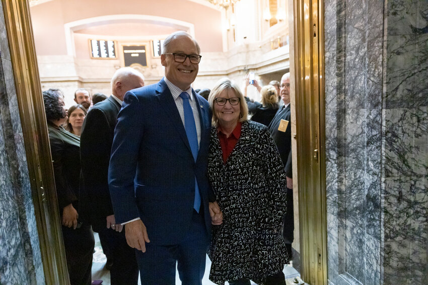 Gov. Jay Inslee and Trudi Inslee pose for a photo on the last day of the 2024 Legislature at the state Capitol on Thursday, March 7.