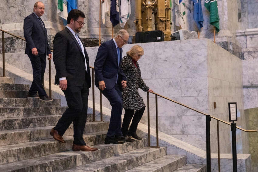 Gov. Jay Inslee and Trudi Inslee walk down to the governor’s office on the last day of the 2024 Legislature at the state Capitol on Thursday, March 7.