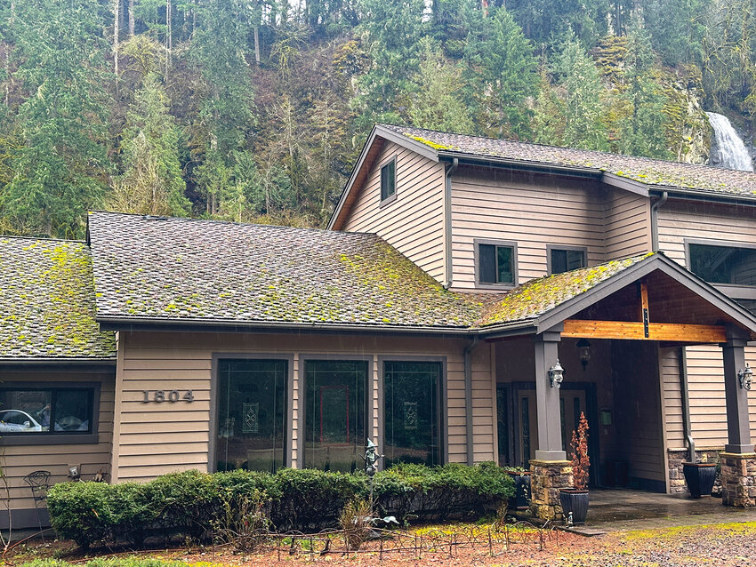 The thick, mossy roof on a home is removed after treatment by Clean Choice Professional Services.