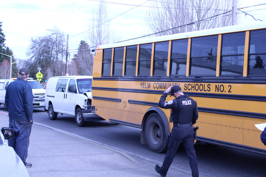 Yelm Police responds to a two-vehicle collision involving a school bus and a van in front of the Yelm Community Schools district office on March 8.