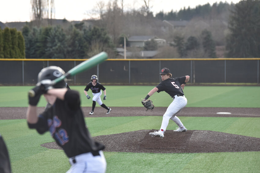 Yelm RHP Wyatt Robison winds up to deliver a pitch against the Lakes Lancers on Friday, March 8 in the team's home opener.