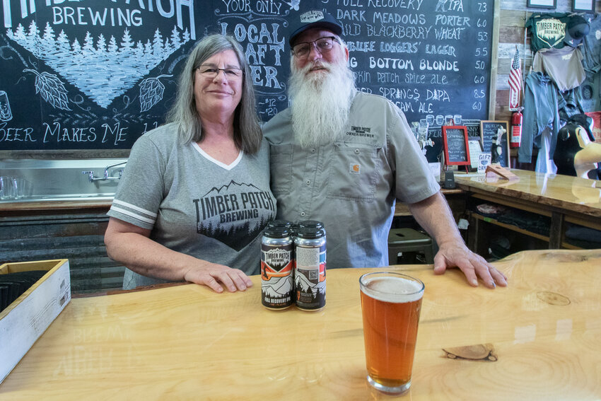 Laurie and Jim Judd, owners of Timber Patch Brewery in Morton, stand behind the brewery's bar on Thursday, March 7, as they prepare to debut their newly canned beer, Full Recovery IPA, next week to celebrate the brewery's fourth anniversary.