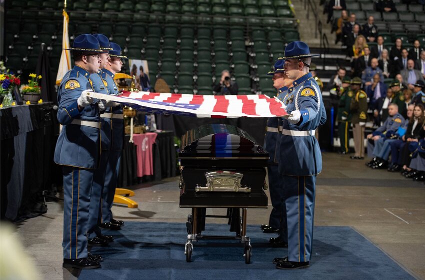 A flag is draped over the casked of Washington State Patrol Trooper Christopher Gadd at his funeral.